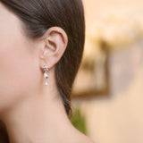 Model Wearing Starfish Cowrie Drop Earrings in Sterling Silver