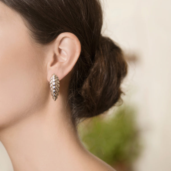 Model Wearing Pangolin Haka Earrings in Sterling Silver